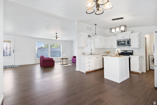2600 North Hill Field Road, Unit 86 Layton, UT 84041 - Photo 4 of 25 Kitchen featuring suspended lighting, light countertops, a kitchen island, white cabinetry, and ornamental molding