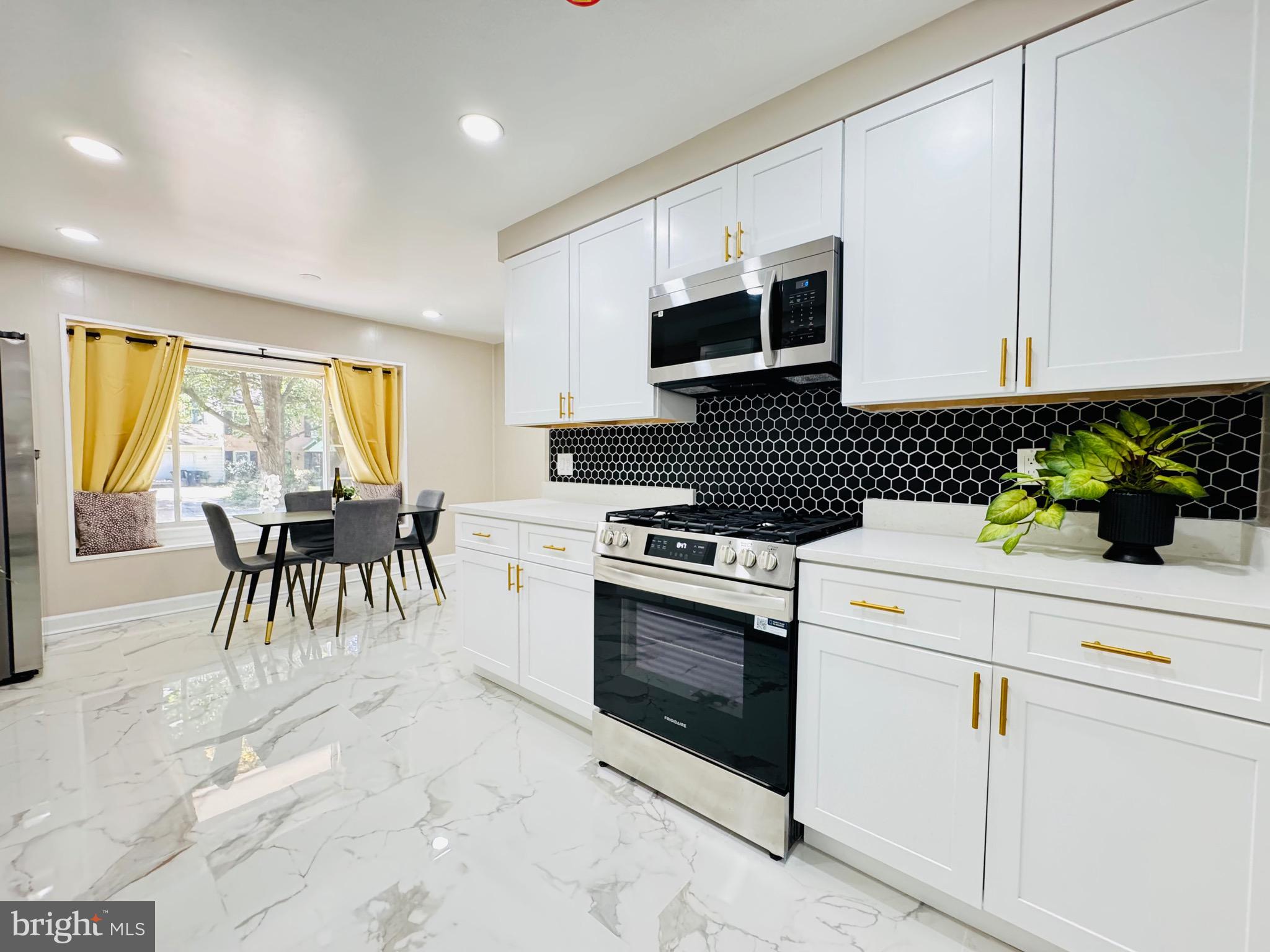 12306 Dendron Place Fort Washington, MD 20744 - Photo 11 of 48 a kitchen with granite countertop white cabinets and white appliances