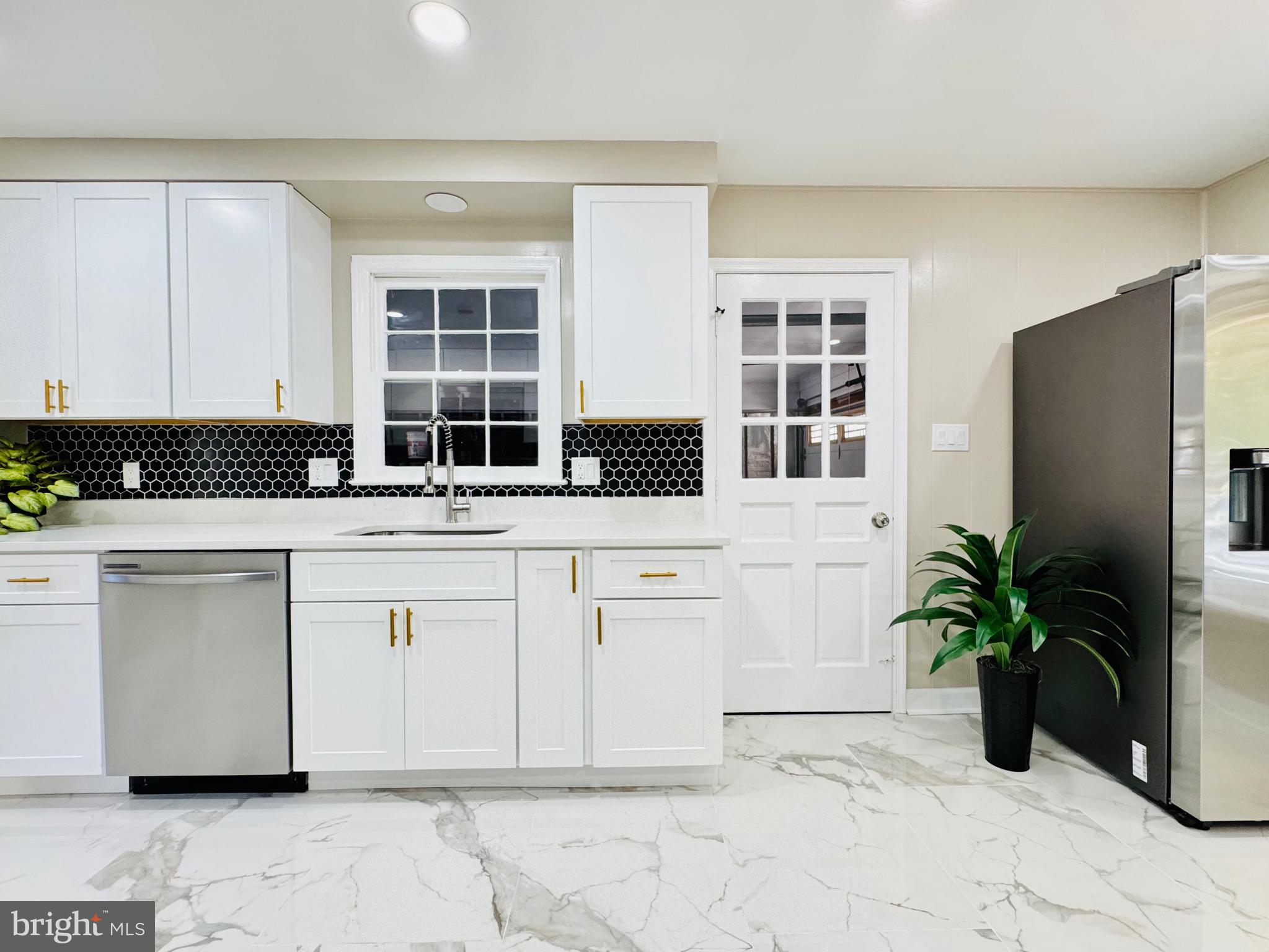 12306 Dendron Place Fort Washington, MD 20744 - Photo 10 of 48 a white kitchen with granite countertop a stove a sink and a white cabinets