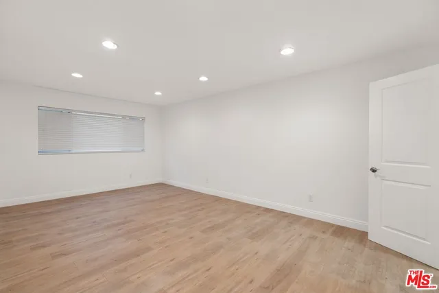 a bathroom with a granite countertop sink a toilet a mirror and shower