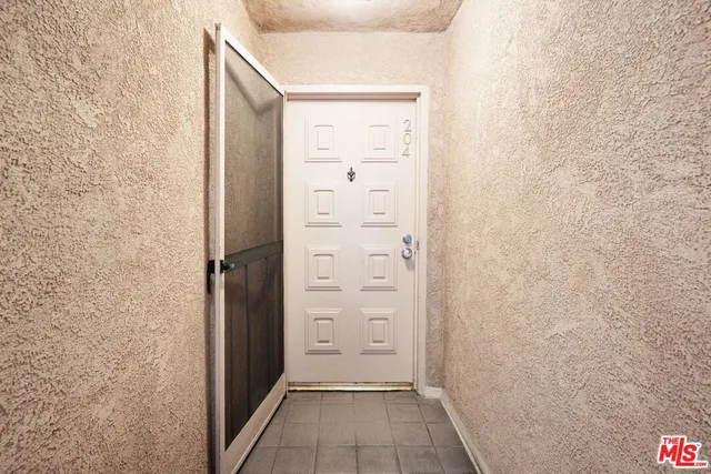 an empty room with wooden floor and fireplace