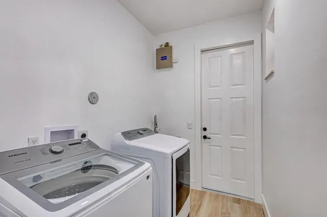 an empty room with a window and a ceiling fan