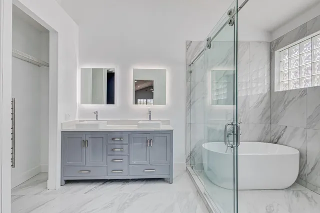 a white toilet sitting next to a bathroom sink