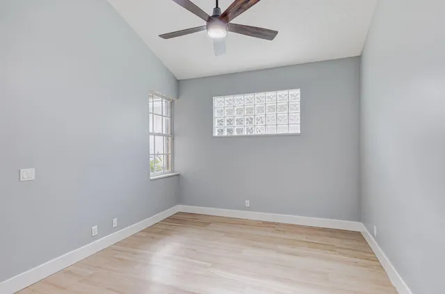 a bathroom with a toilet sink vanity and mirror