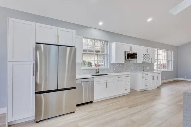 a view of a kitchen with a sink and a window