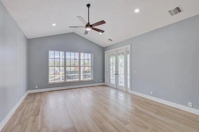 a spacious bathroom with a tub sink and mirror