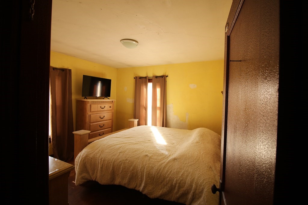 218 Lawton Street Fall River, MA 02721 - Photo 14 of 28 a bedroom with a bed and a tv