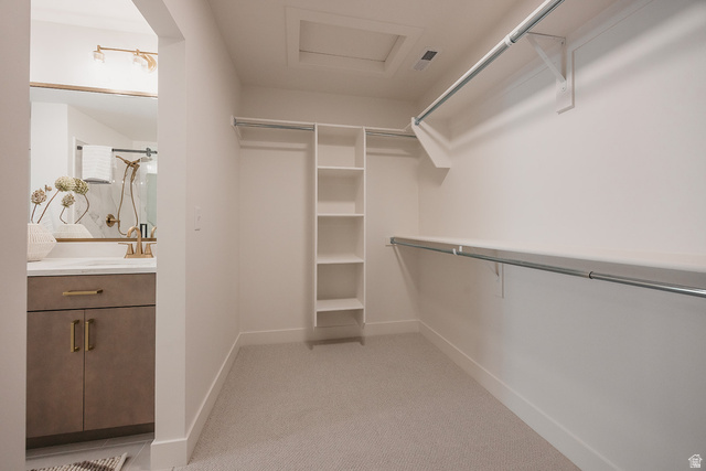 5902 Canyon Rim Road, Unit 620 Lehi, UT 84048 - Photo 50 of 78 Spacious walk-in closet with carpet flooring, built-in shelving, and dual hanging rods