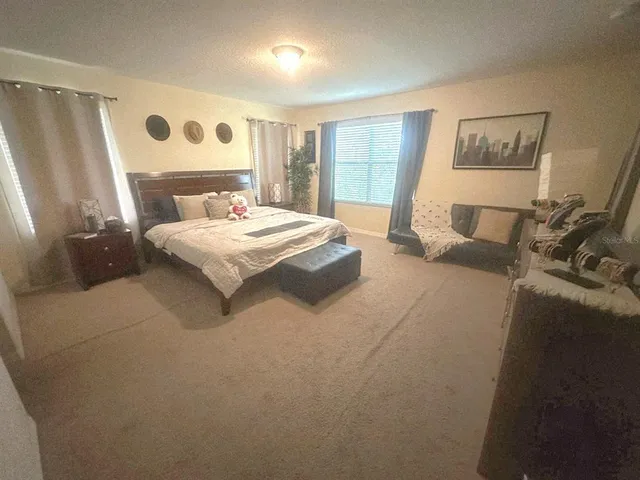 a bedroom with a bed and a large mirror