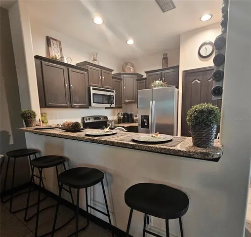 a kitchen with stainless steel appliances granite countertop a sink and cabinets