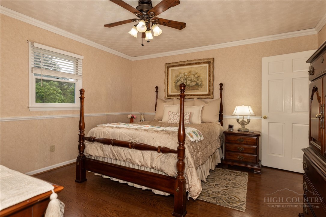 1335 Shingle Gap Road Purlear, NC 28665 - Photo 23 of 49 a bedroom with a bed and a chandelier