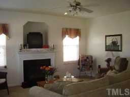 7004 Spanglers Spring Way Raleigh, NC 27610 - Photo 2 of 6 a living room with furniture and a fireplace