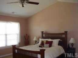 7004 Spanglers Spring Way Raleigh, NC 27610 - Photo 5 of 6 a bedroom with a bed and window