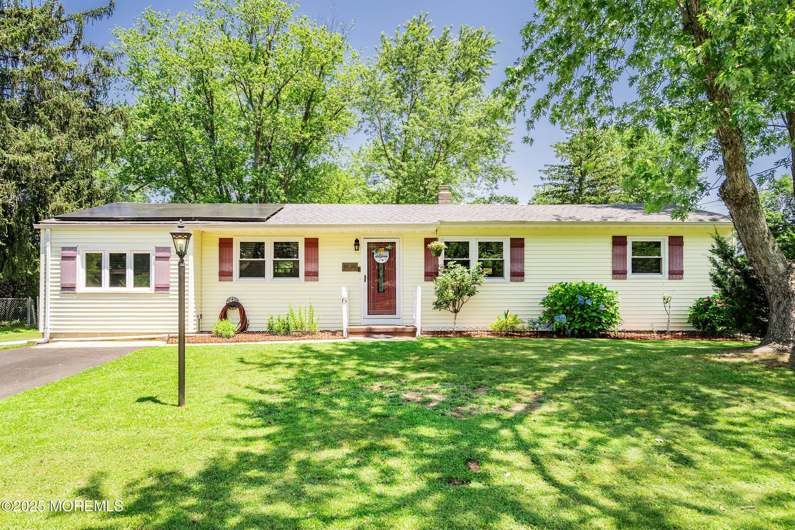 a view of a house with a yard and a patio