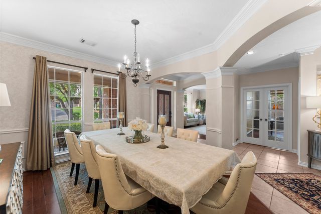 a view of a dining room with furniture wooden floor and chandelier