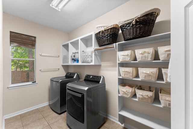 a utility room with cabinets dryer and washer