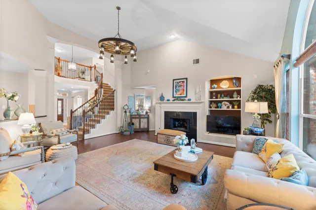 a living room with furniture fireplace and a chandelier