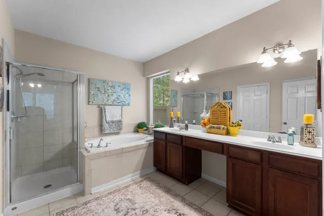 a bathroom with a double vanity sink mirror and shower