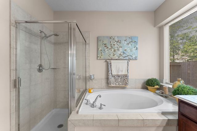 a bathroom with a tub and shower