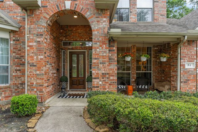 front view of a brick house with a large window