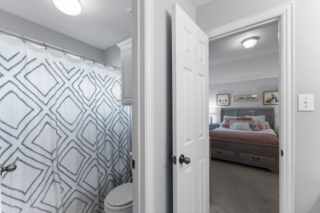 a bedroom with a bed and a couch