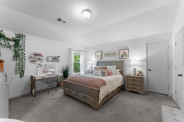 a bedroom with a bed and a table in it