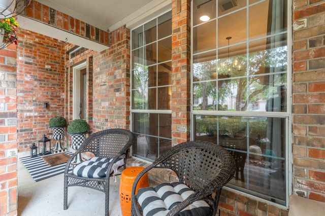 a balcony with table and chairs