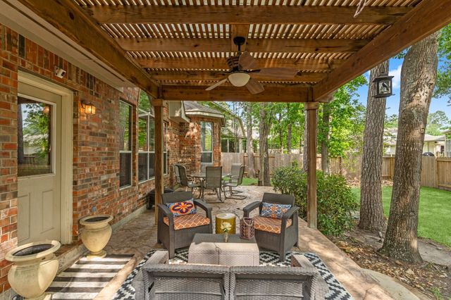 a outdoor space with the couches and dining table with the garden view