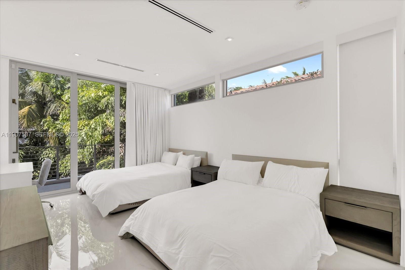 7830 Atlantic Way Miami Beach, FL 33141 - Photo 13 of 34 a bedroom with two beds and a large window