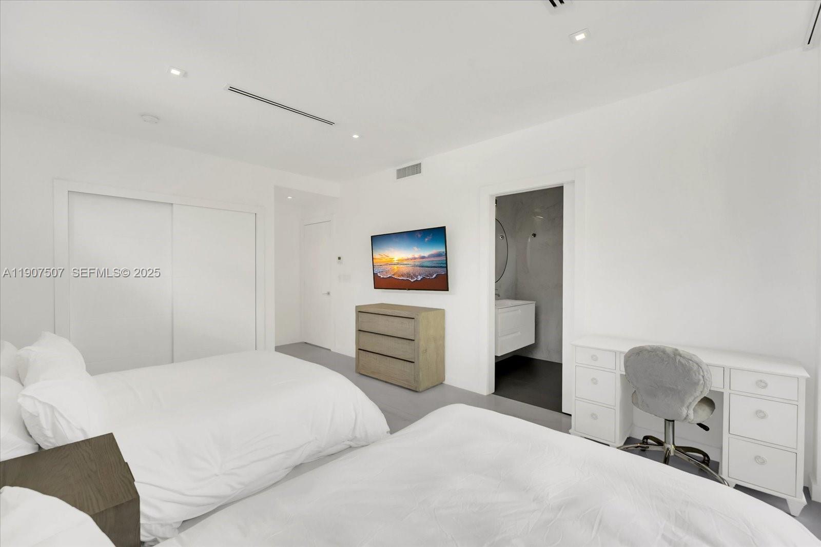7830 Atlantic Way Miami Beach, FL 33141 - Photo 14 of 34 a bedroom with a bed and furniture
