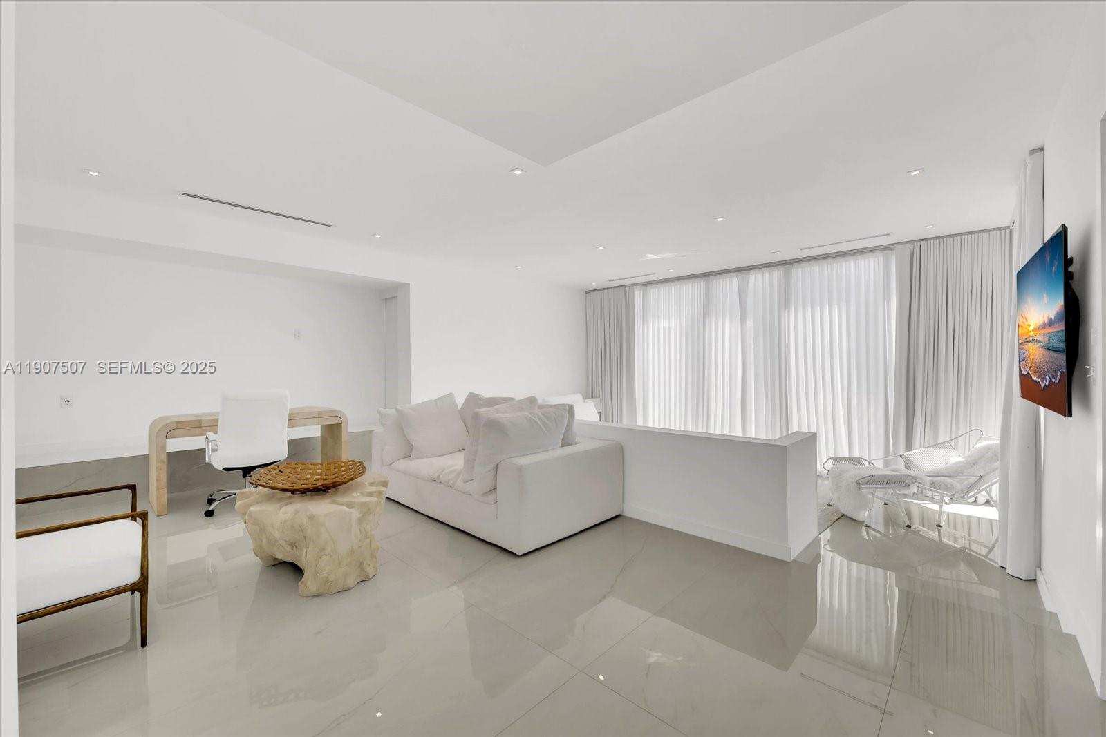 7830 Atlantic Way Miami Beach, FL 33141 - Photo 15 of 34 a living room with furniture and a flat screen tv