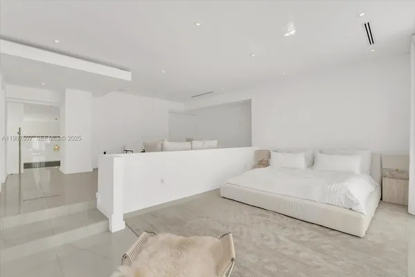 a living room with furniture and a large mirror