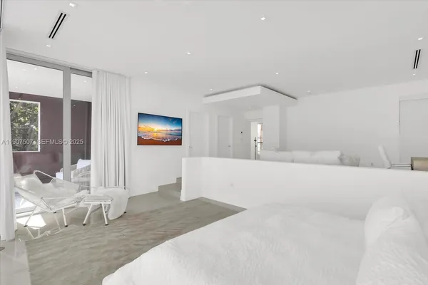 a bedroom with a bed and a mirror