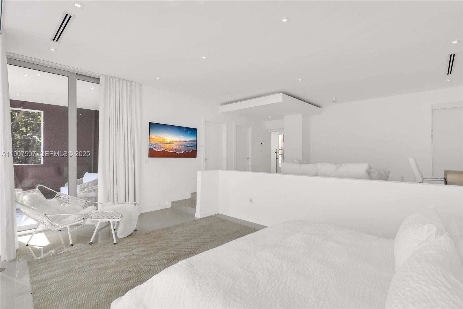 7830 Atlantic Way Miami Beach, FL 33141 - Photo 18 of 34 a bedroom with a bed and a mirror