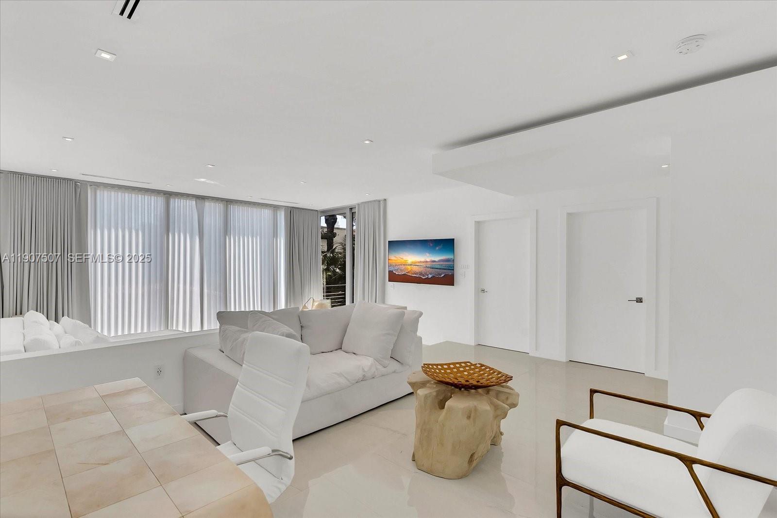 7830 Atlantic Way Miami Beach, FL 33141 - Photo 19 of 34 a living room with furniture and a window