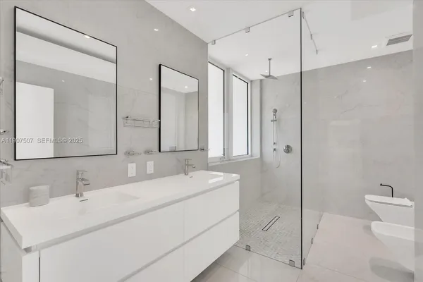 a bathroom with a double vanity sink mirror and toilet