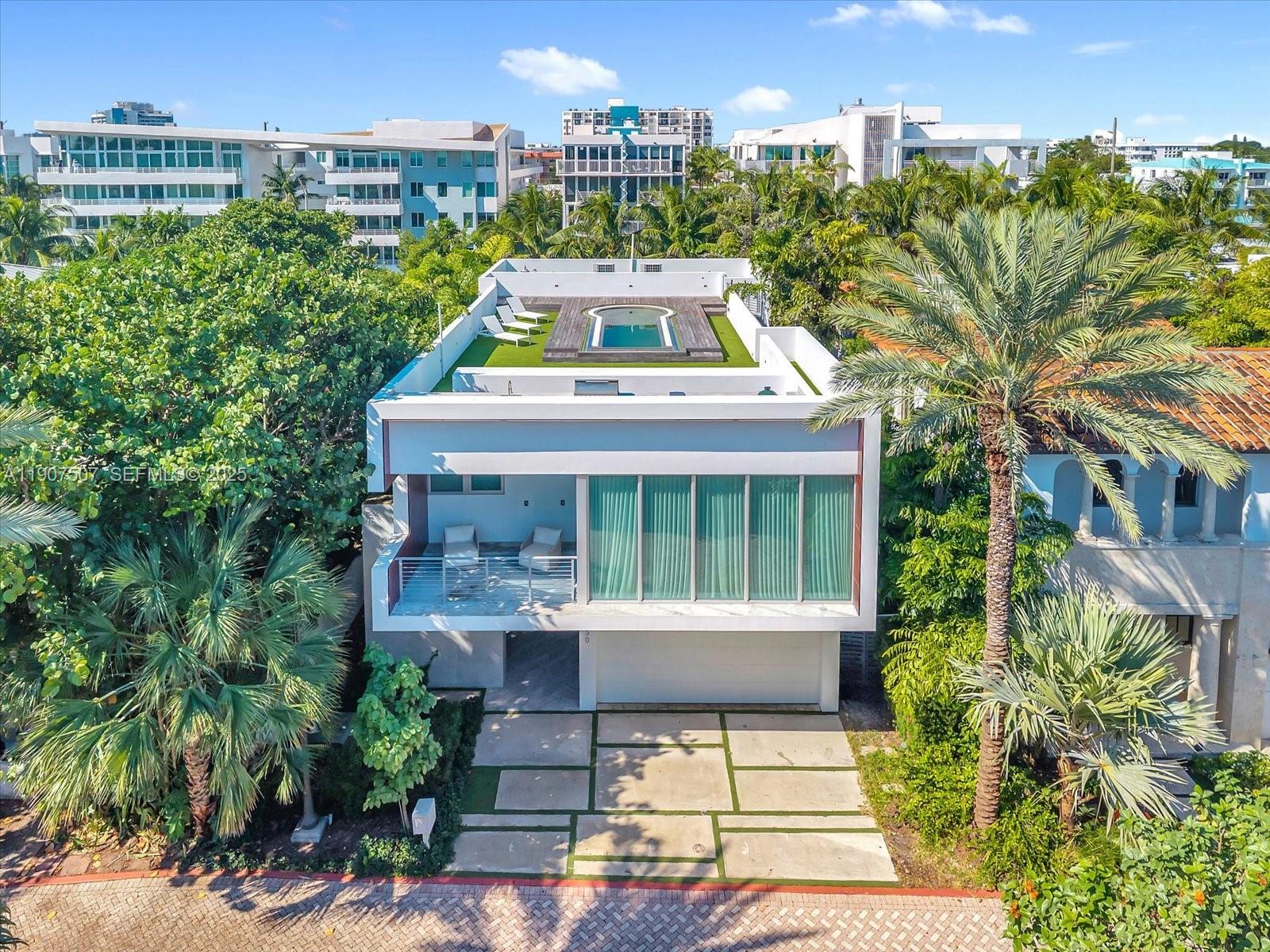 7830 Atlantic Way Miami Beach, FL 33141 - Photo 2 of 34 a front view of a house with a garden