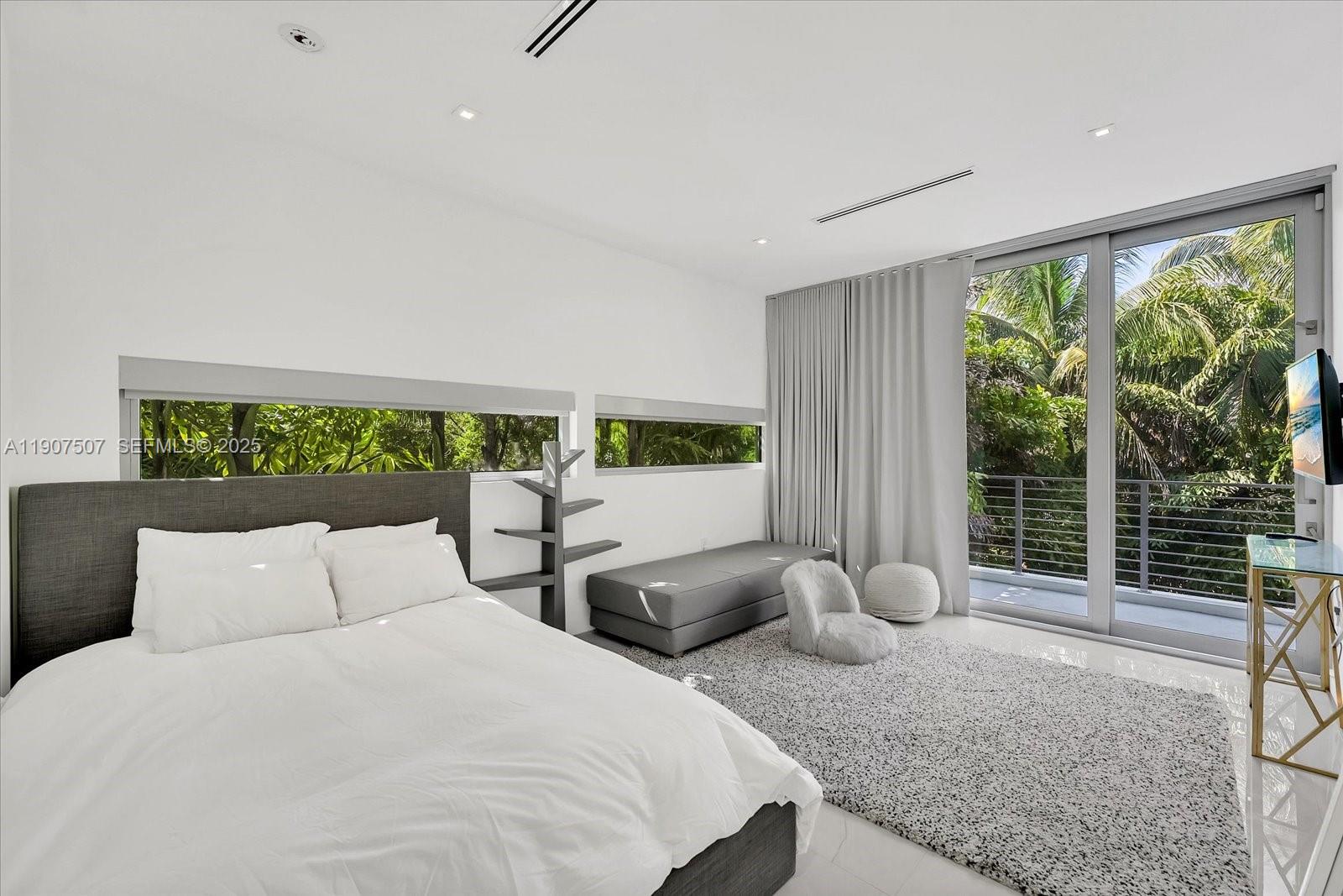 7830 Atlantic Way Miami Beach, FL 33141 - Photo 21 of 34 a bedroom with large bed and a large window