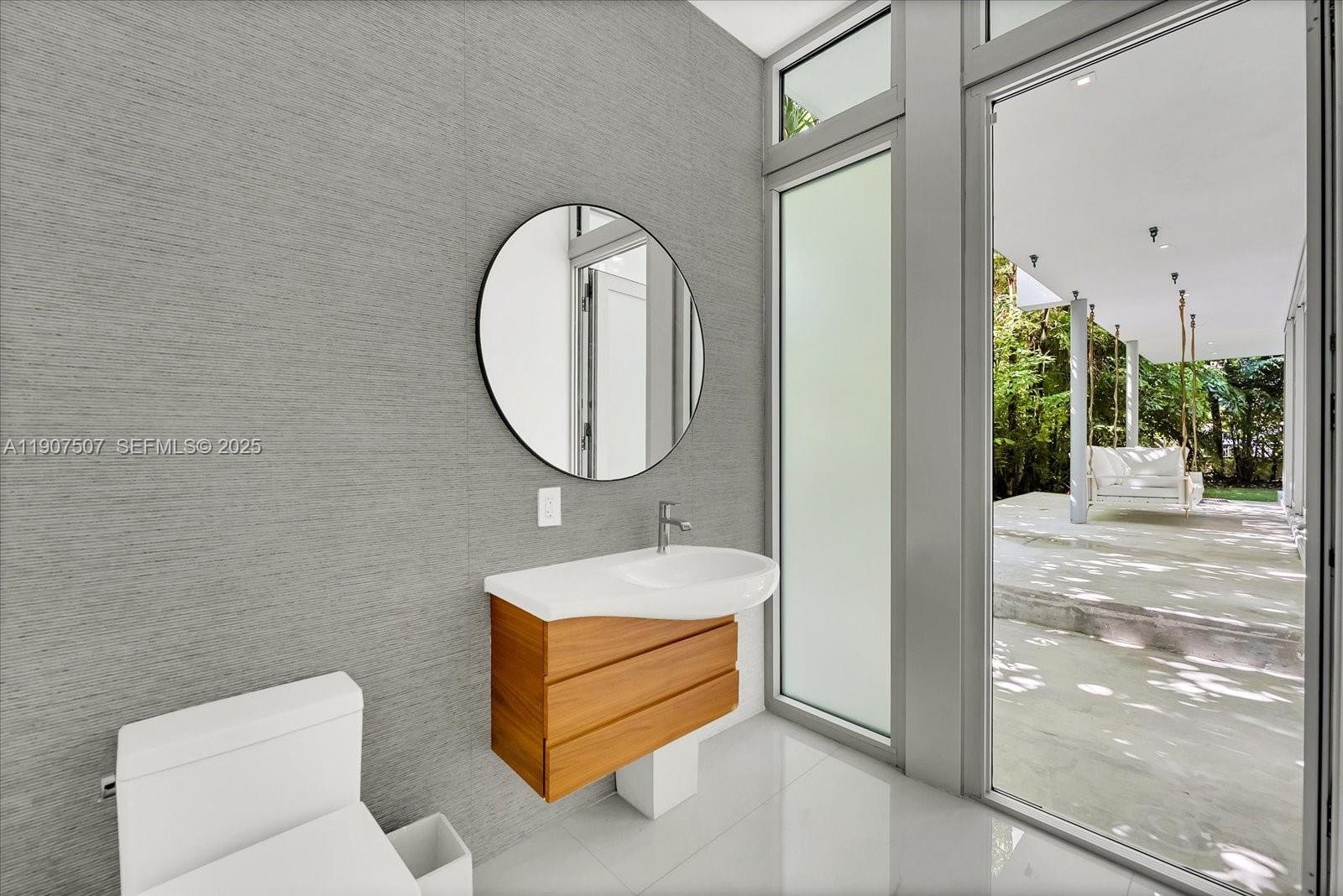 7830 Atlantic Way Miami Beach, FL 33141 - Photo 22 of 34 a bathroom with a sink and a mirror