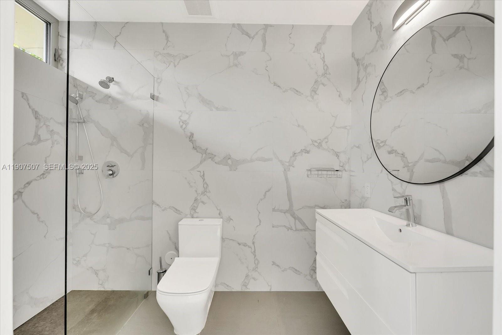 7830 Atlantic Way Miami Beach, FL 33141 - Photo 23 of 34 a bathroom with a sink a toilet and shower