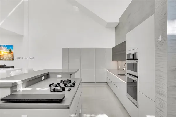 a kitchen with a sink appliances and cabinets
