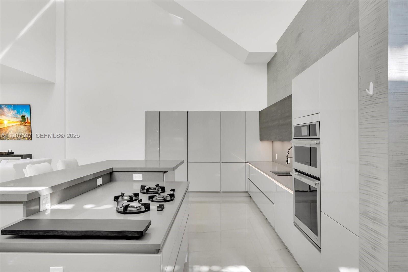 7830 Atlantic Way Miami Beach, FL 33141 - Photo 4 of 34 a kitchen with a sink appliances and cabinets