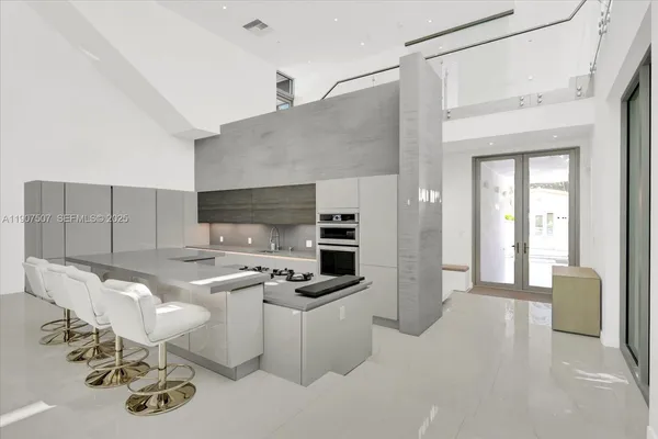 a kitchen with stainless steel appliances a sink stove and cabinets