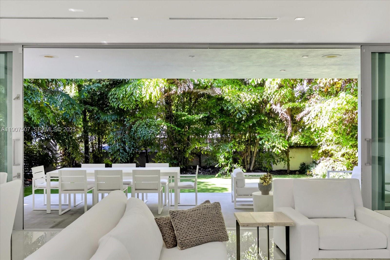 7830 Atlantic Way Miami Beach, FL 33141 - Photo 9 of 34 a outdoor living space with furniture and a garden