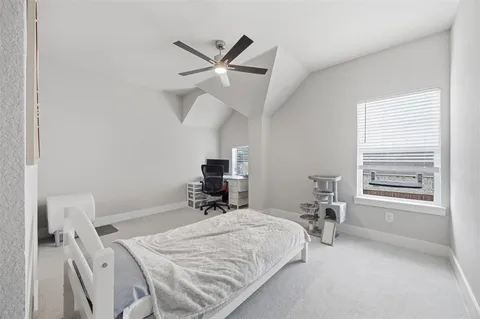 a bedroom with a bed a table and a window