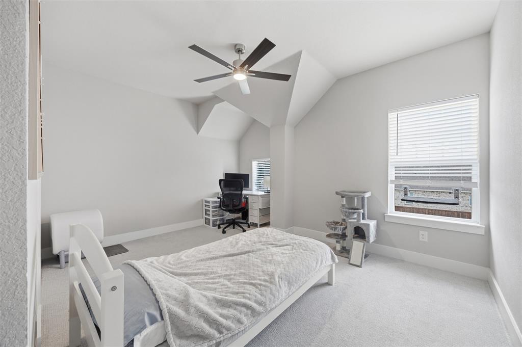 5805 Heatherwood Loop Sachse, TX 75048 - Photo 32 of 39 a bedroom with a bed a table and a window