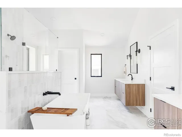 a bathroom with a tub sink and mirror