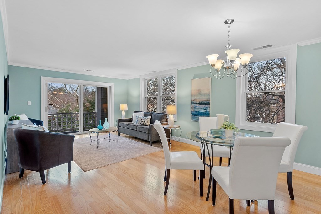 25 Holly Lane, Unit 2A Brookline, MA 02467 - Photo 1 of 34 a living room with couch a table and a chandelier
