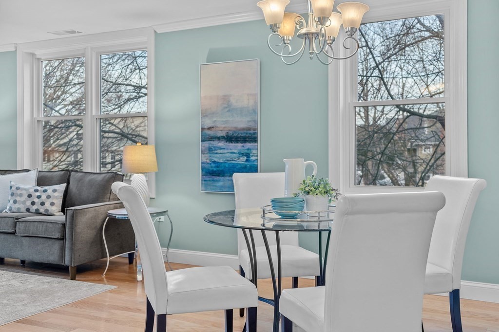 25 Holly Lane, Unit 2A Brookline, MA 02467 - Photo 16 of 34 a view of a dining room with furniture a chandelier and wooden floor