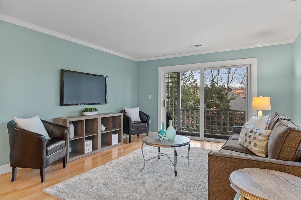 25 Holly Lane, Unit 2A Brookline, MA 02467 - Photo 17 of 34 a living room with furniture and a flat screen tv